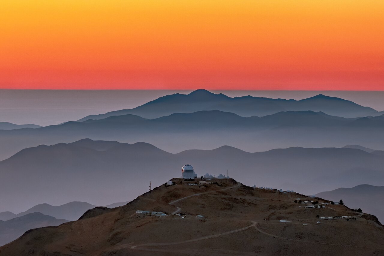 Cerro Tololo seen from a distance with a stunning view over the Cordillera at sunset.